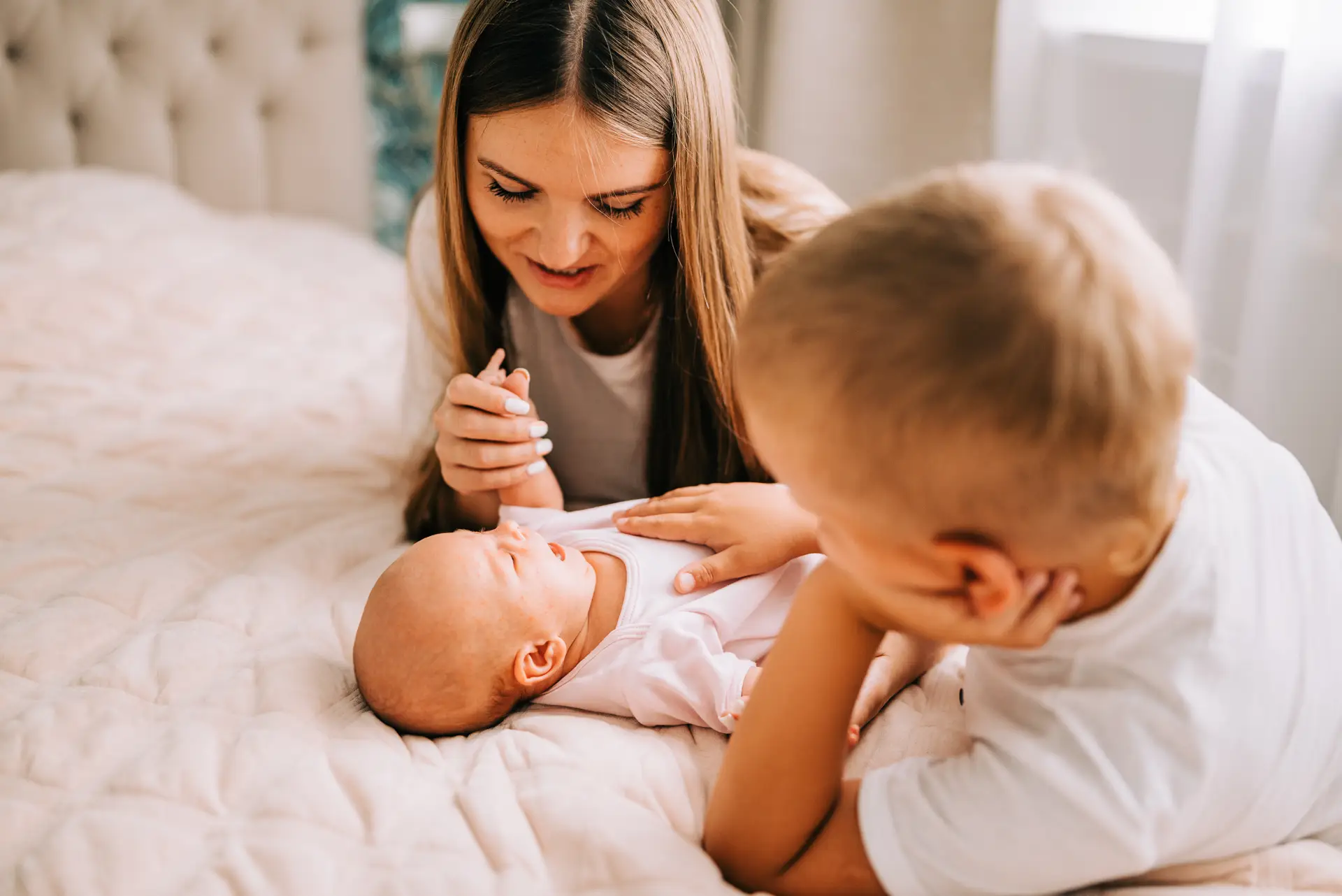 A mother and her young son with a newborn